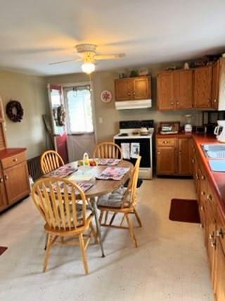 107 Oliphant Road Uniontown, PA 15401 - Photo 7 of 14 a dining hall with stainless steel appliances granite countertop a stove a sink a dining table and chairs with wooden floor