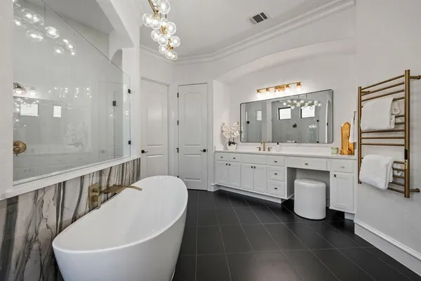 a bathroom with a double vanity sink a mirror and a bathtub