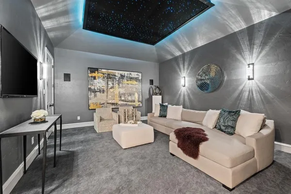 a living room with furniture a large window and a flat screen tv