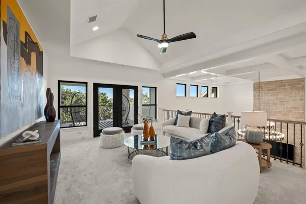 a living room with furniture large window and flat screen tv