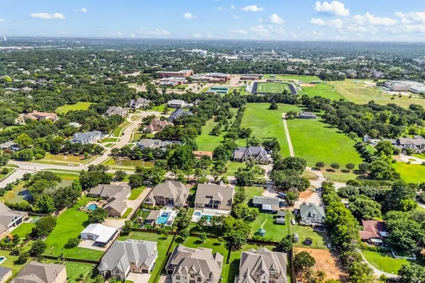 an aerial view of residential houses with outdoor space