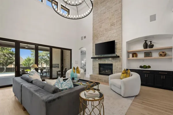 a living room with furniture a fireplace and a large window