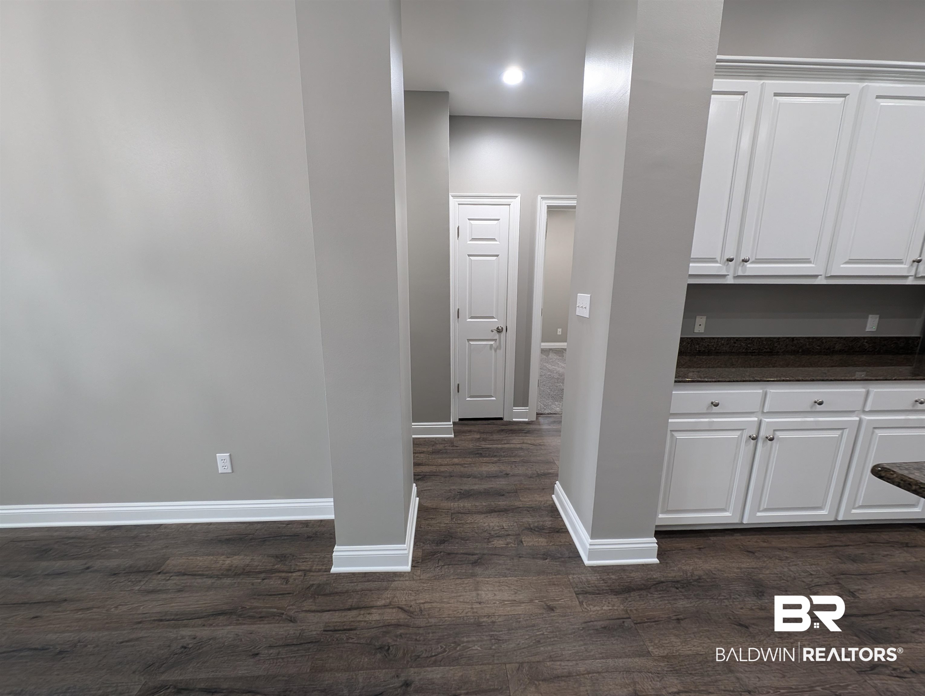 11623 Halcyon Loop Daphne, AL 36526 - Photo 36 of 90 Hallway beside the kitchen leading to the guest wing of the house featuring three additional bedrooms and guest bathroom