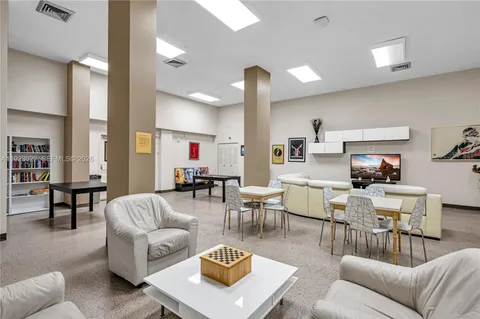 a living room with furniture kitchen view and a table