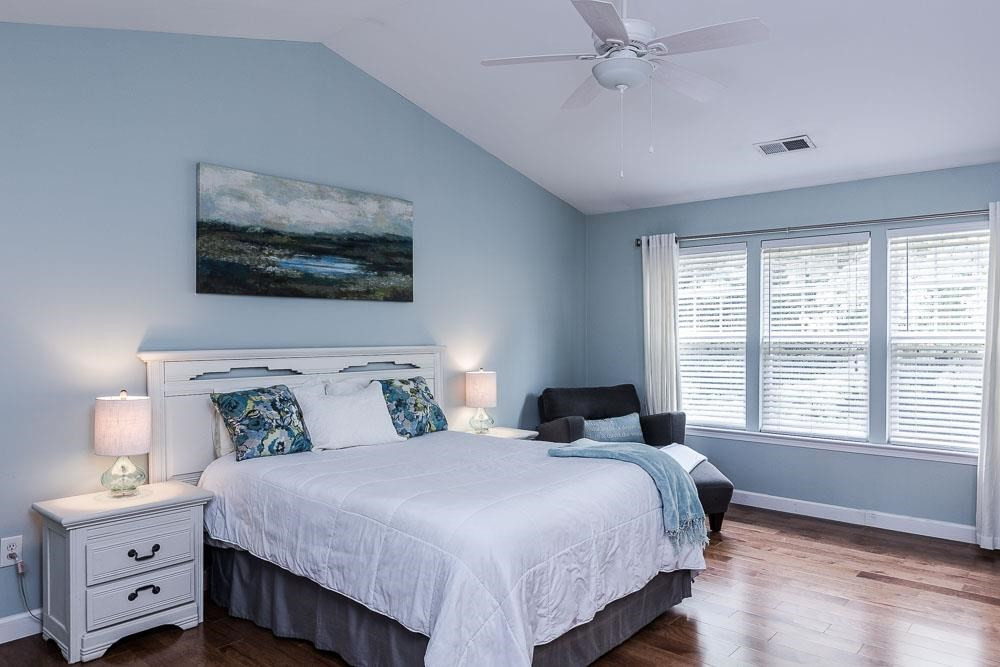 8305 Chimneycap Drive Raleigh, NC 27613 - Photo 14 of 30 Cathedral ceilings, a wall of windows, and wide open space for your king bed, a sitting area, and his/hers chests! Master Suite