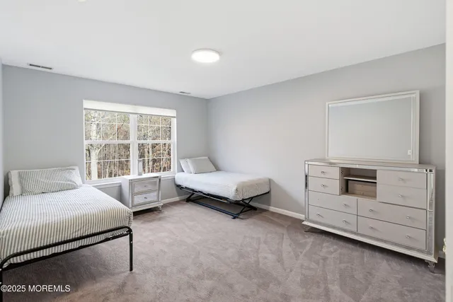 a spacious bedroom with a bed and a window