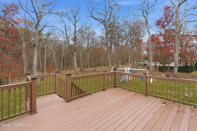 a view of a balcony with wooden floor and fence