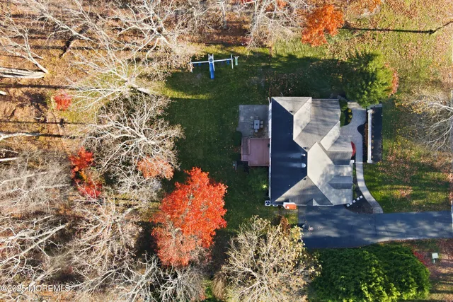 an aerial view of a house with a yard