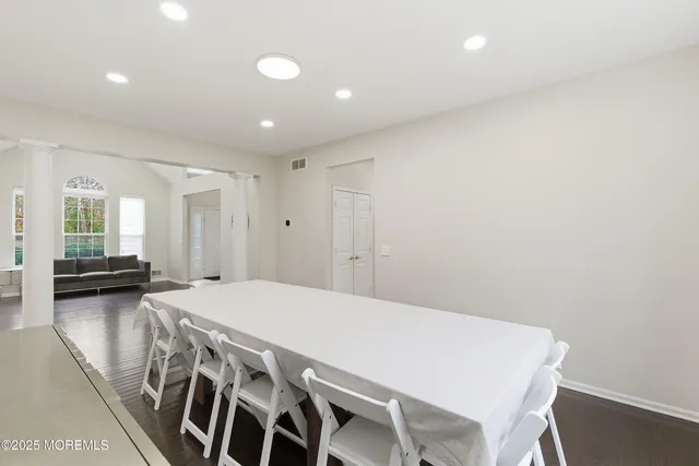 a view of a room with furniture and wooden floor