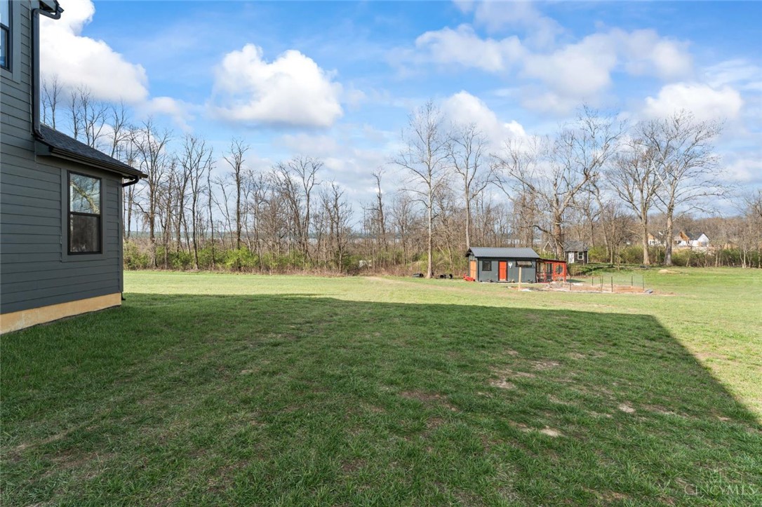 2425 Middleboro Road Clarksville, OH 45113 - Photo 12 of 91 Expansive green grounds and wooded views offer a serene escape.