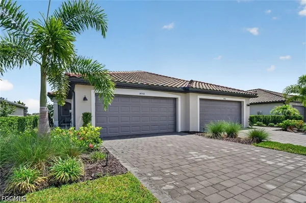 a front view of a house with a yard and garage