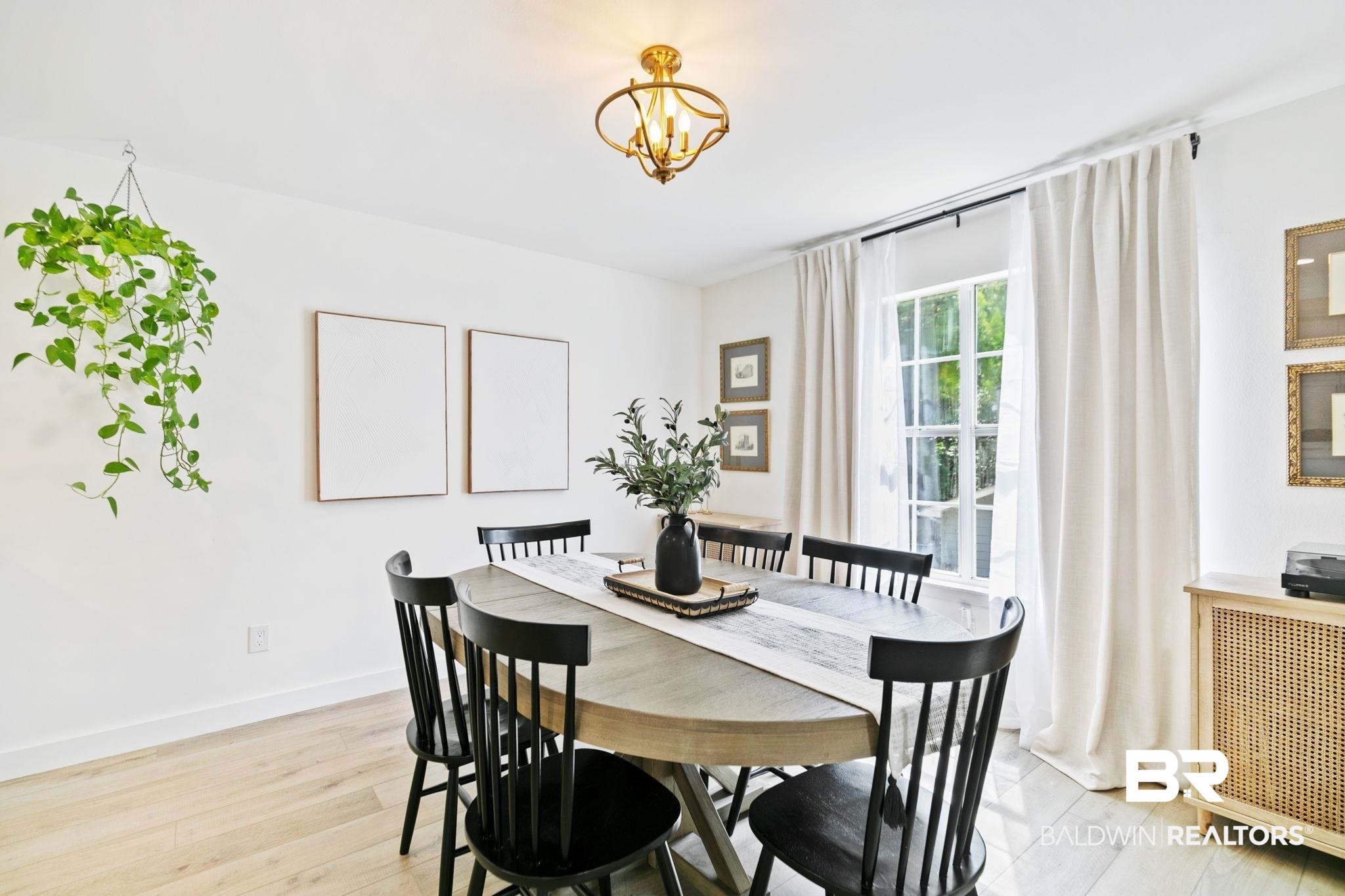 342 Ridgewood Drive Daphne, AL 36526 - Photo 35 of 36 Dining room with light wood-type flooring and an inviting chandelier