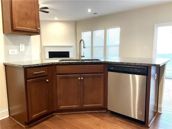 a kitchen with granite countertop wooden cabinets and a granite counter tops