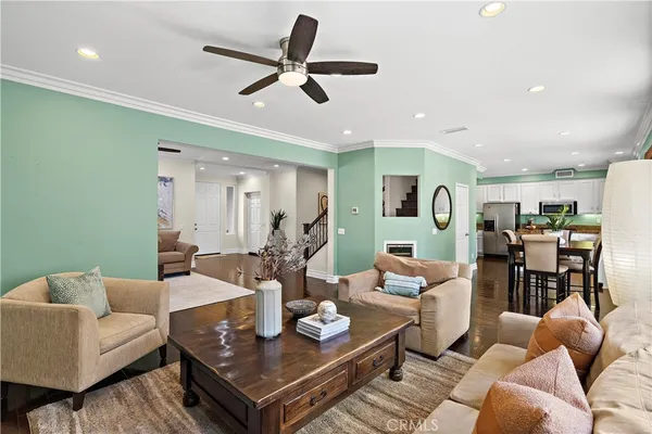 a living room with furniture and a view of kitchen