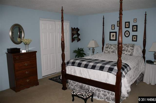 3985 Belmore Way Reno, NV 89503 - Photo 6 of 13 a bedroom with a bed and a dresser in it