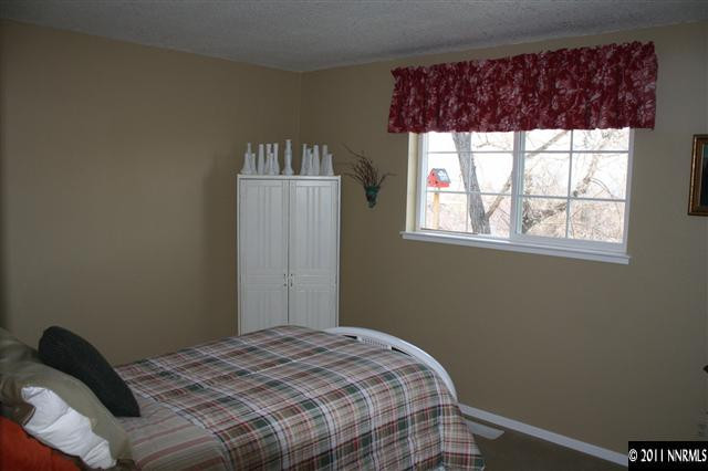 3985 Belmore Way Reno, NV 89503 - Photo 9 of 13 a bedroom with a bed and a window