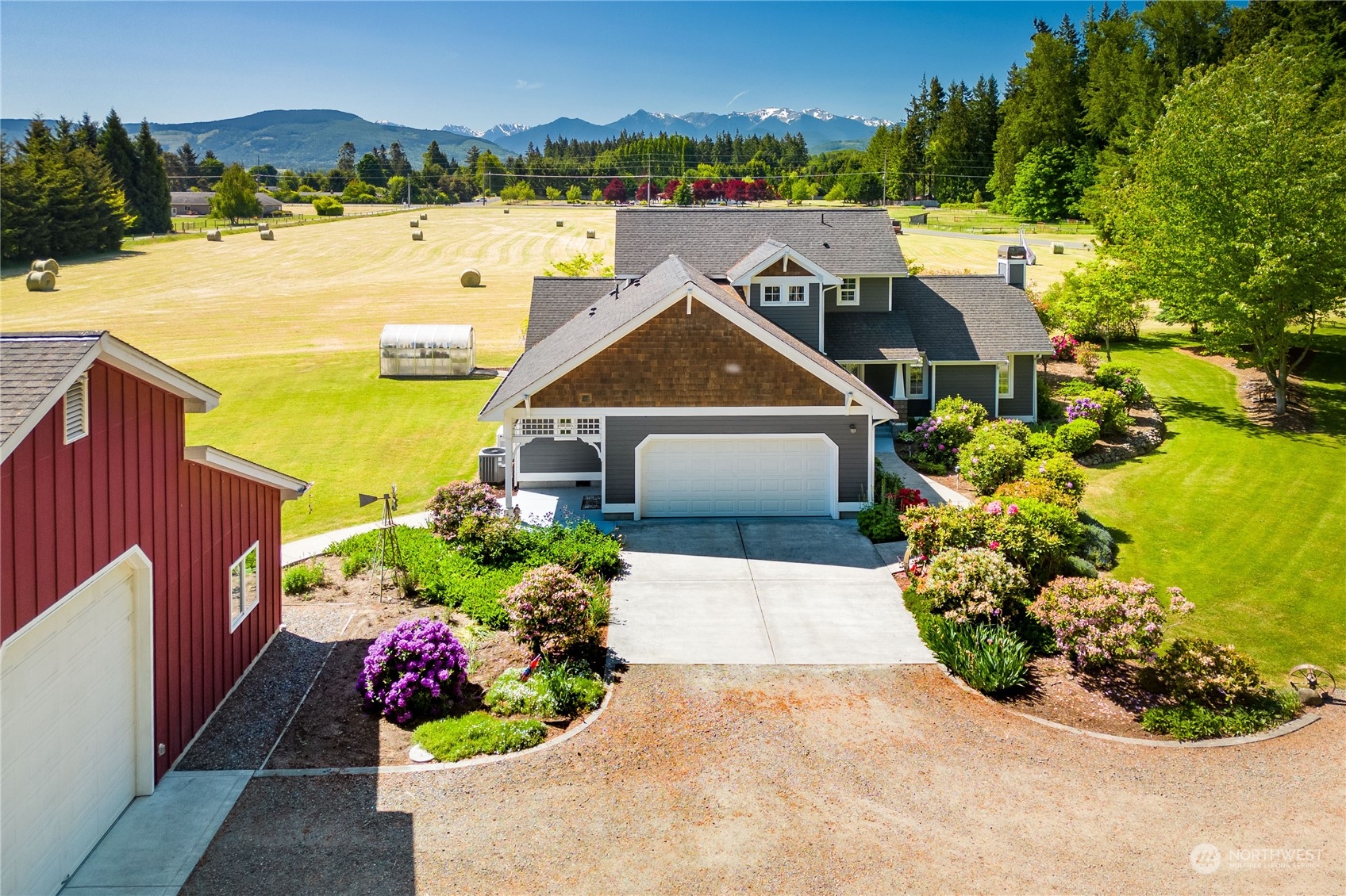 a view of a house with a yard and a pond