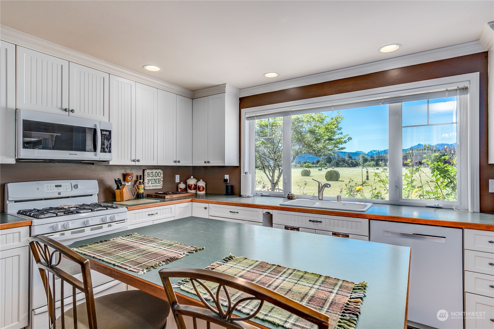 174 Lot 9&10 Knutsen Farm Road Sequim, WA 98382 - Photo 17 of 40 a kitchen with stainless steel appliances granite countertop a stove a sink and a microwave