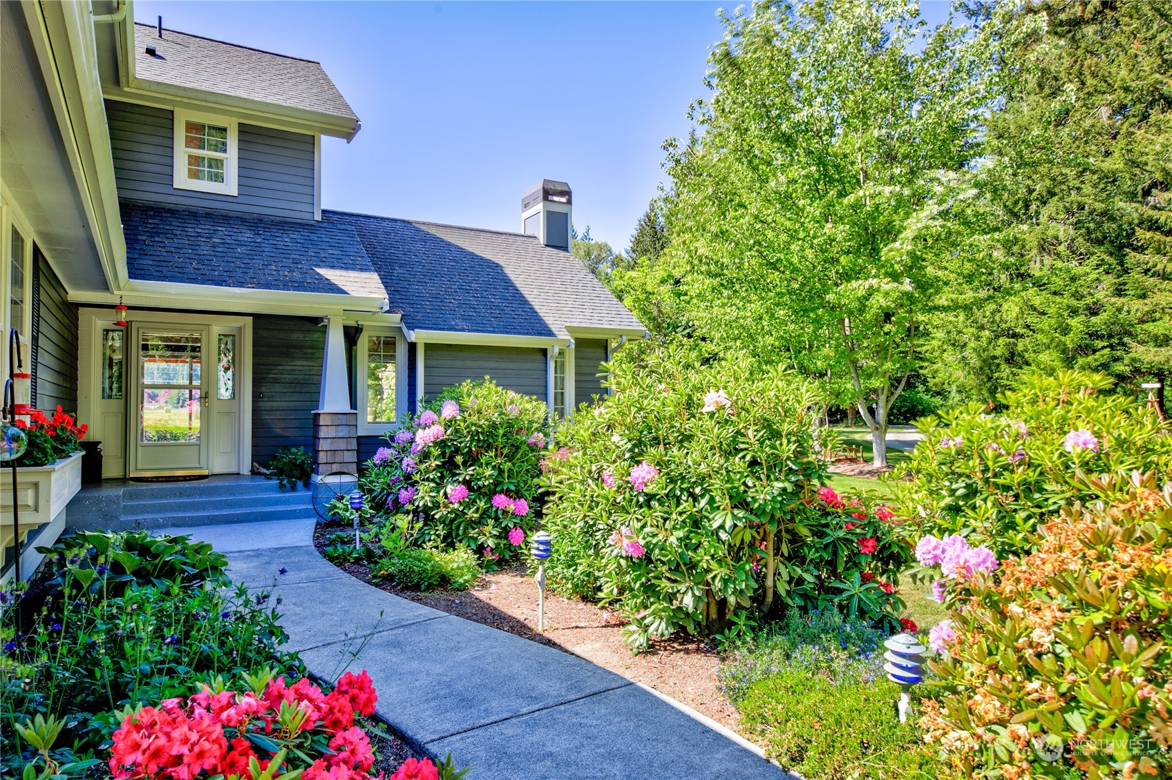 174 Lot 9&10 Knutsen Farm Road Sequim, WA 98382 - Photo 8 of 40 a front view of a house with a yard and fountain