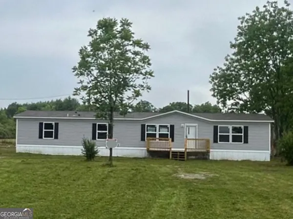 a front view of house with a garden