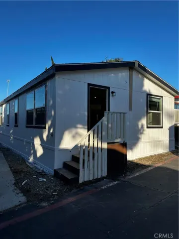 a backyard of a house with wooden floor fire pit and outdoor space