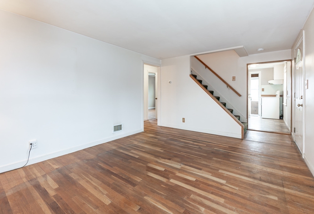 11 Colonial Road Woburn, MA 01801 - Photo 8 of 39 a view of a room with wooden floor and stairs