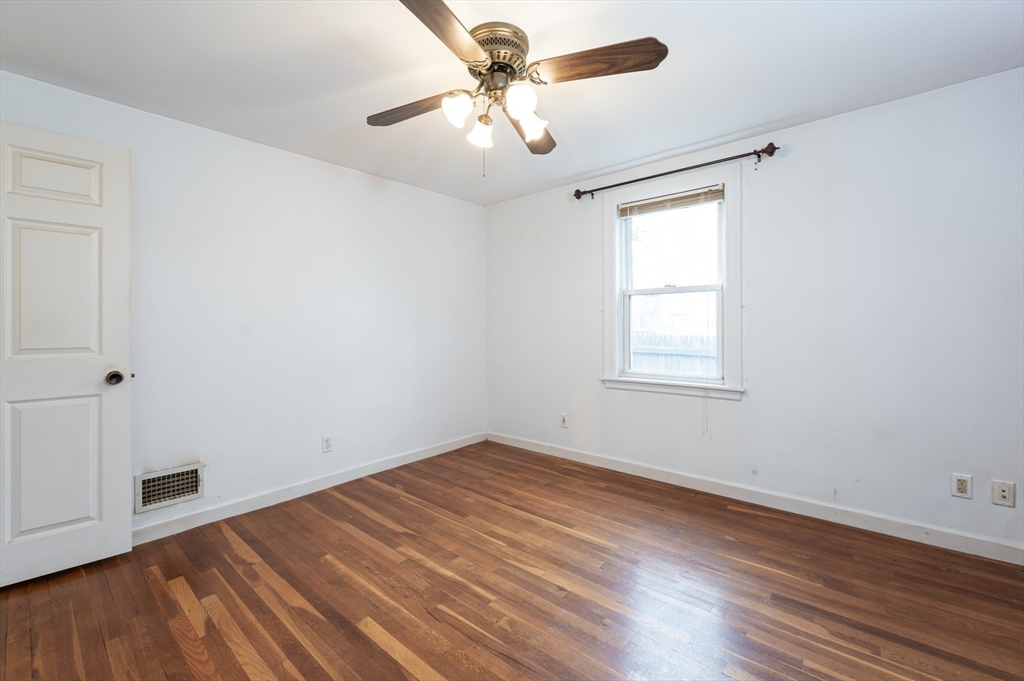 11 Colonial Road Woburn, MA 01801 - Photo 9 of 39 wooden floor in an empty room with a window