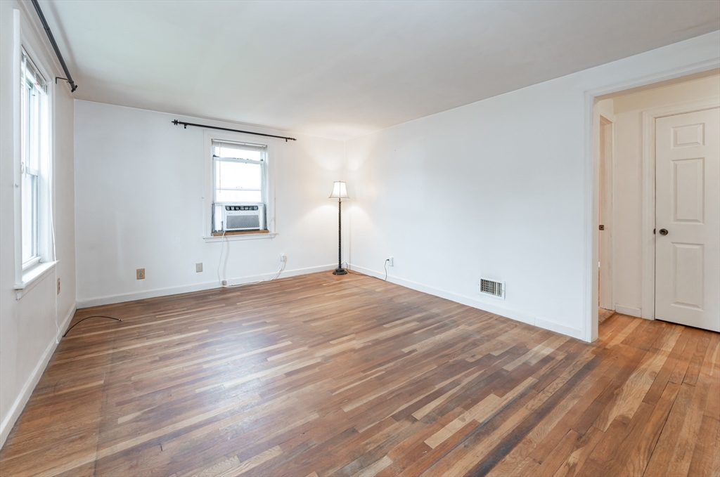11 Colonial Road Woburn, MA 01801 - Photo 10 of 39 a view of empty room with wooden floor and fan