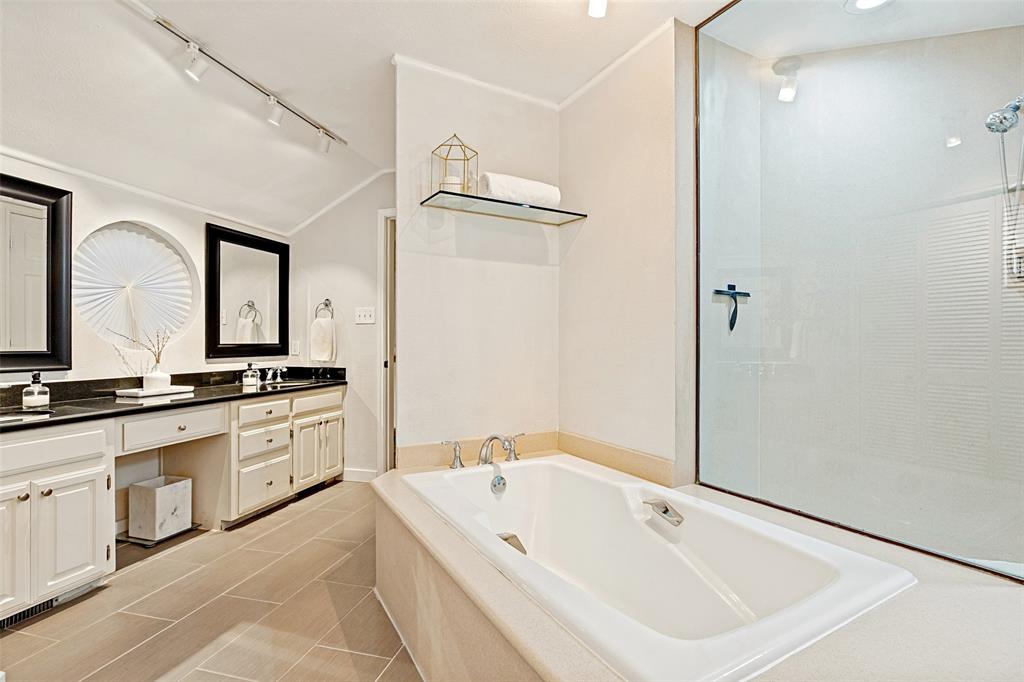 3642 Word Street Dallas, TX 75204 - Photo 24 of 29 a spacious bathroom with a double vanity sink and a mirror