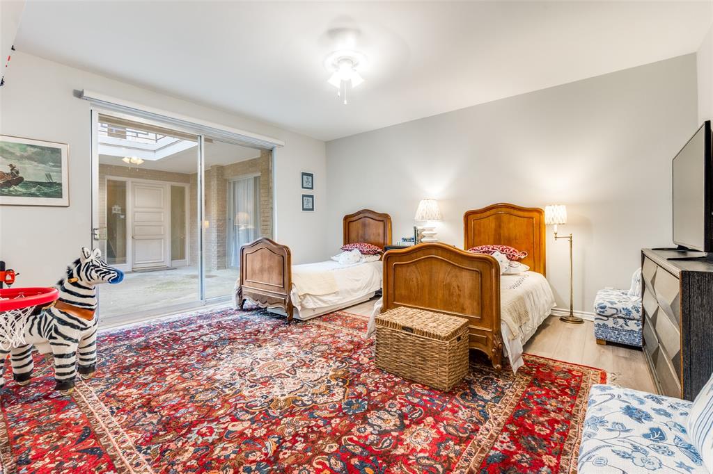 6306 Bandera Avenue, Unit B Dallas, TX 75225 - Photo 11 of 14 Room featuring light wood-finish flooring, white walls, and a ceiling fan