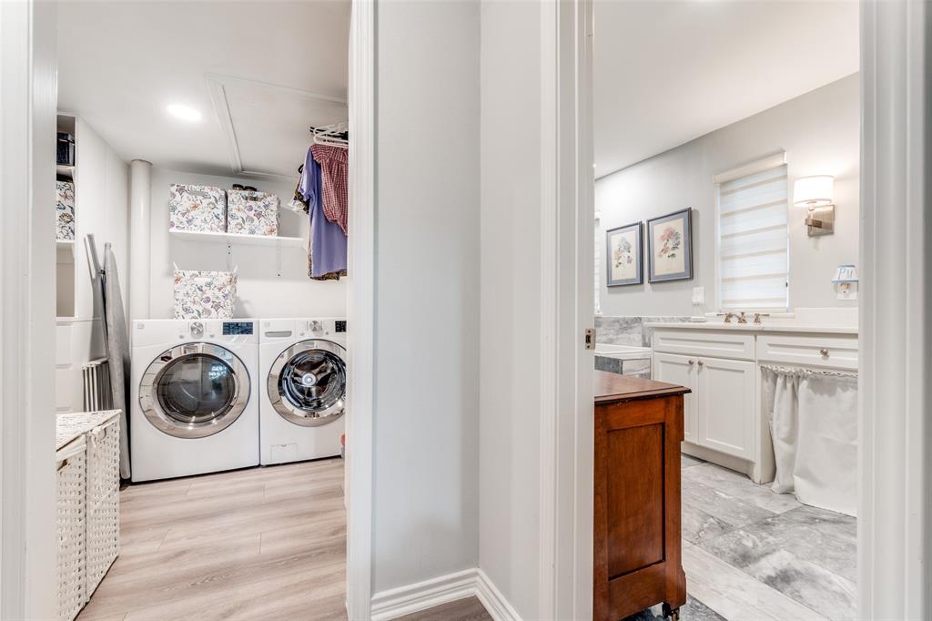 6306 Bandera Avenue, Unit B Dallas, TX 75225 - Photo 9 of 14 Dedicated laundry room featuring light wood-finish flooring, built-in shelving, and two front-loading appliances