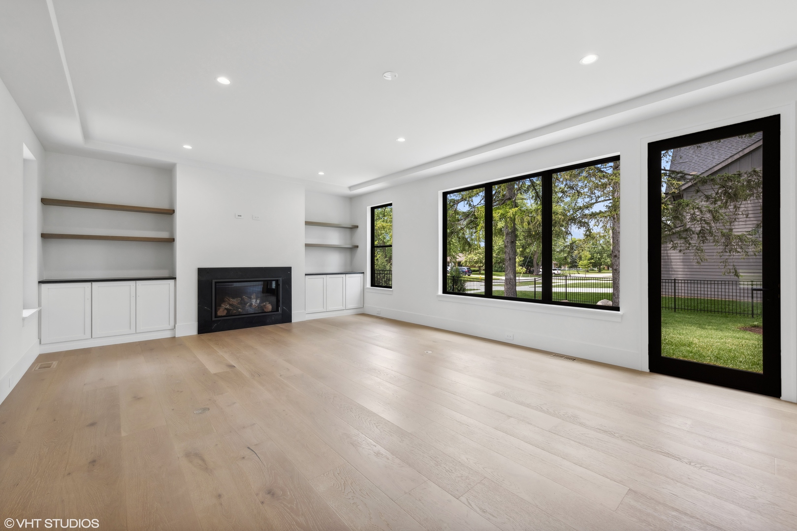 62 Miller Road Lake Zurich, IL 60047 - Photo 20 of 48 a view of an empty room with a fireplace and a window