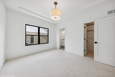 a view of a hallway with wooden floor and entryway