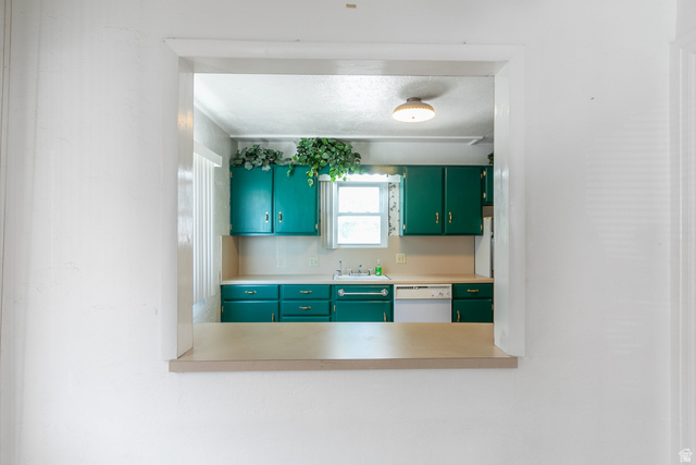 59 East Pinehurst Street Tooele, UT 84074 - Photo 7 of 22 Kitchen pass-through window with a laminate counter