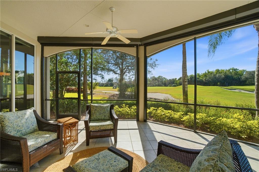 17015 Porta Vecchio Way, Unit 101 Naples, FL 34110 - Photo 2 of 39 a living room with hardwood floor and large windows