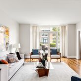 a living room with furniture and a floor to ceiling window