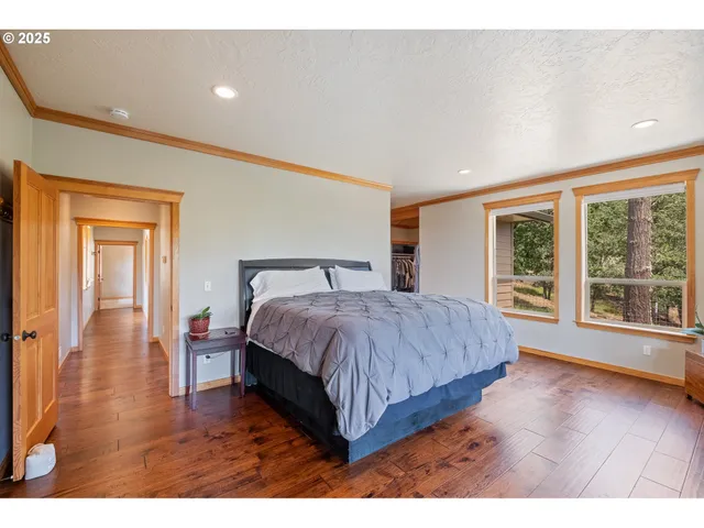 a bedroom with a large bed and a large window