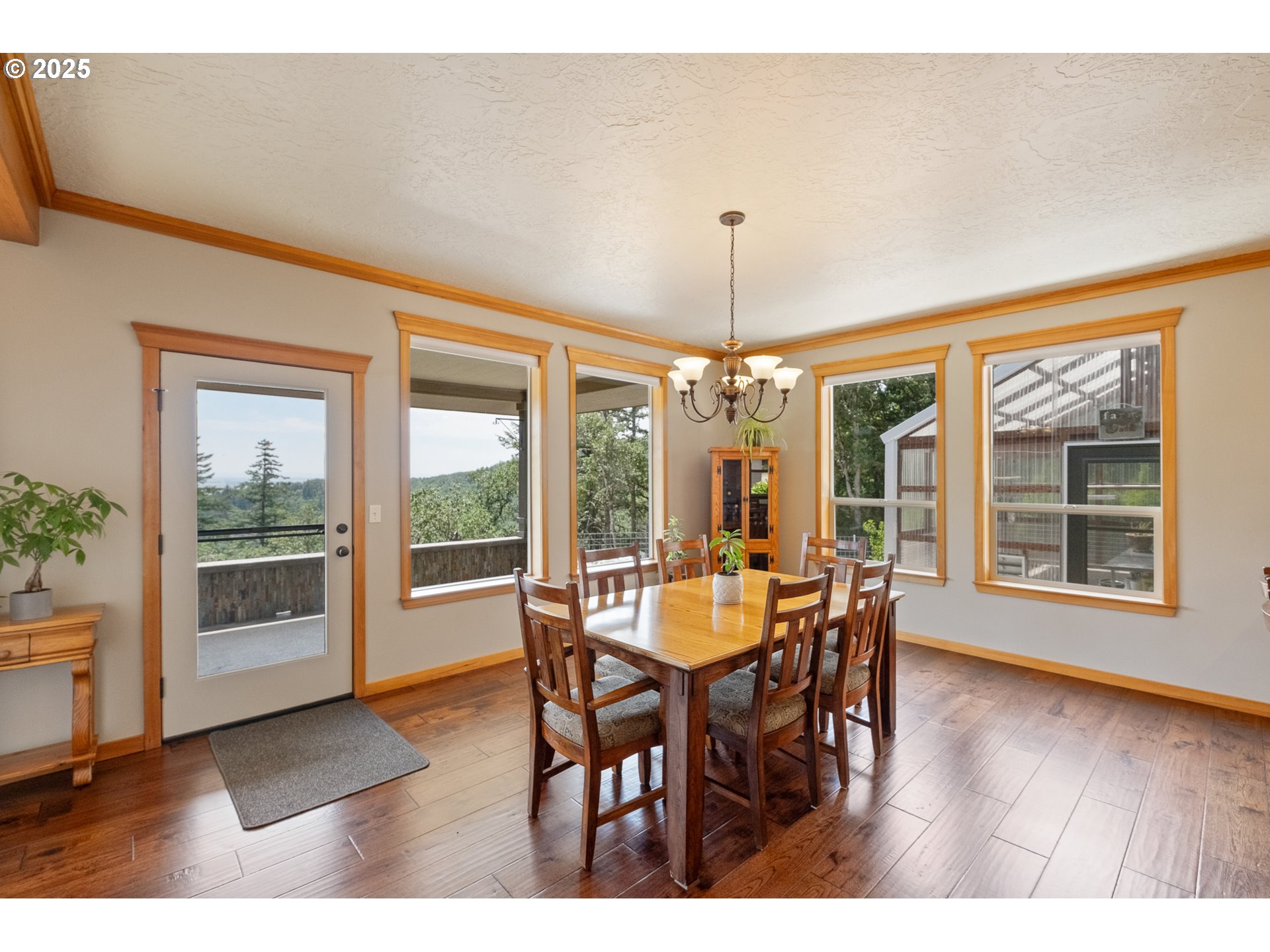 24911 Gap Road Brownsville, OR 97327 - Photo 8 of 44 a dining room with furniture large windows and a chandelier