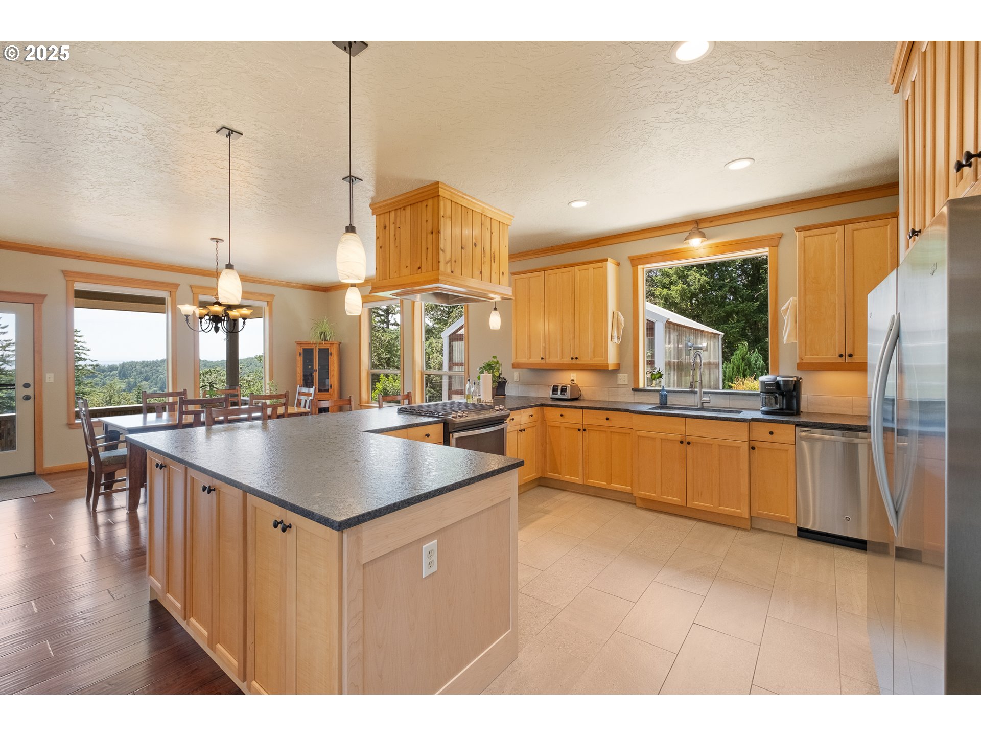 24911 Gap Road Brownsville, OR 97327 - Photo 10 of 44 a kitchen with kitchen island granite countertop a sink a counter top space a large window and stainless steel appliances