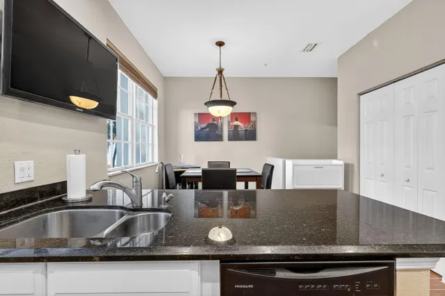 a living room with furniture a fireplace and a chandelier
