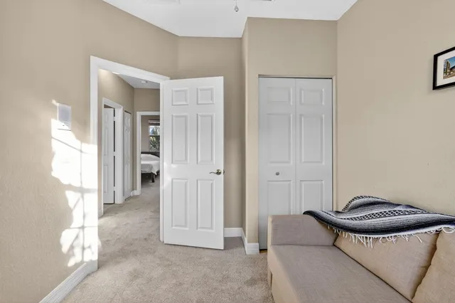 a bedroom with a bed lamp and a chandelier