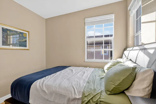 a bedroom with a large bed and a window