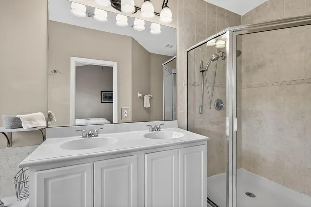 a bathroom with a tub a sink and mirror