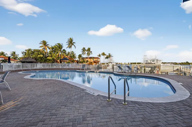 a swimming pool with outdoor seating and yard