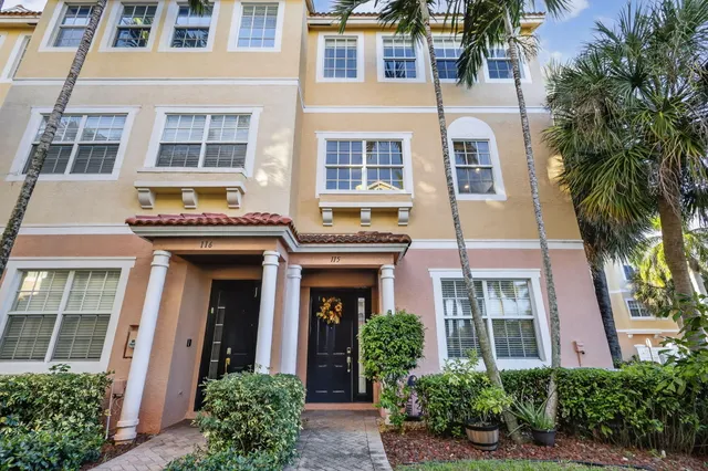 a open kitchen with stainless steel appliances kitchen island granite countertop a table and chairs in it