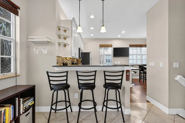 a kitchen with granite countertop a stove cabinets and microwave