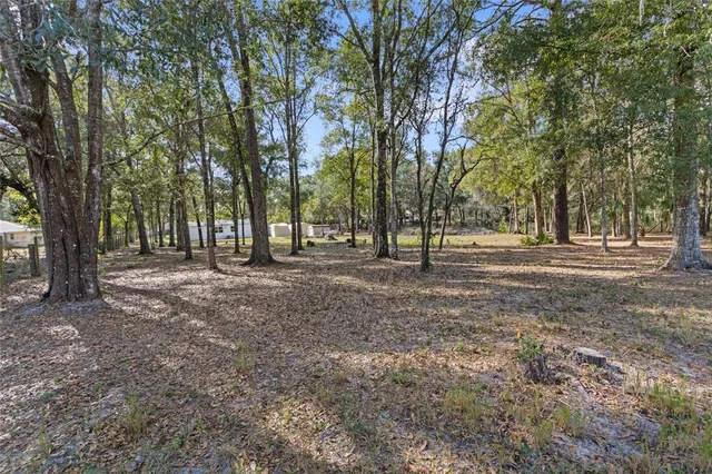 a view of a porch with wooden floor and fence