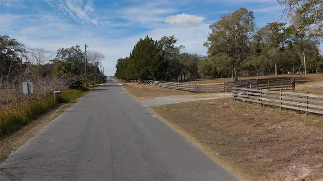 a view of dirt yard with a trees