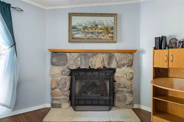 a room with a fireplace and a rug