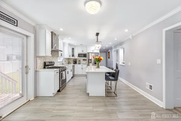 a kitchen with a sink appliances and cabinets